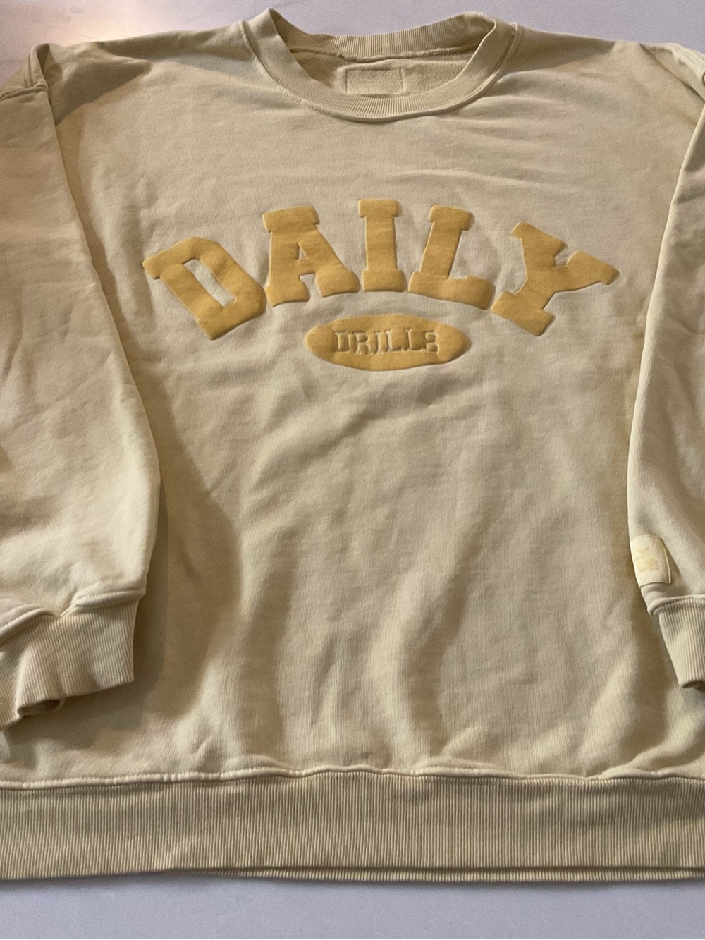 Daily Drills butter Sweatshirt with Yellow Applique Logo